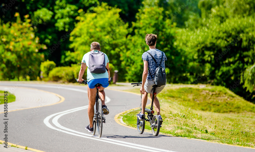 Cyclists ride on the bike path in the city Park
