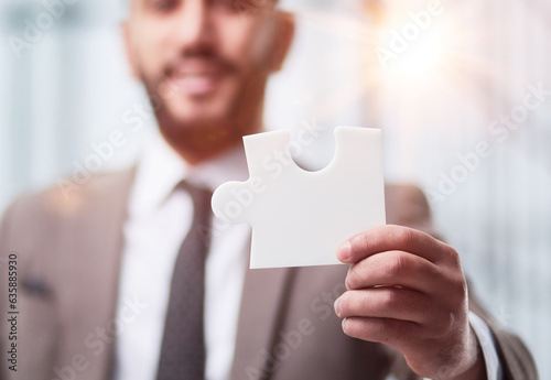 happy businessman holding a puzzle in his hands. Business decisions, success and strategy.