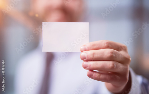 Businessman showing a blank business card, close-up