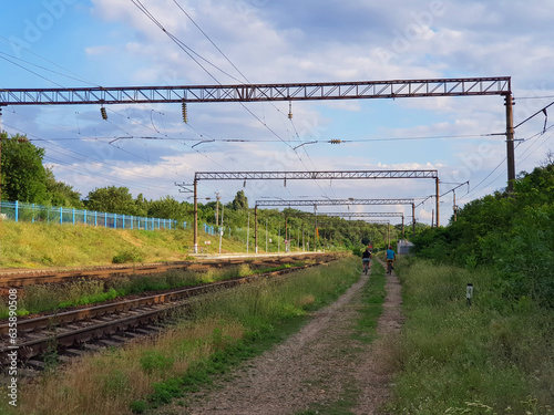 Railway tracks and electric cables. Summer landscape