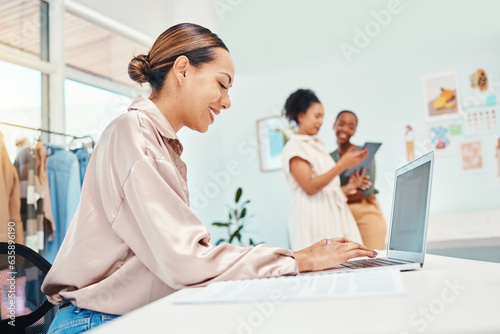 Laptop typing, woman and at a boutique for fashion, communication and working in retail. Smile, ecommerce and a female stylist or girl with a computer for online website for a clothing store