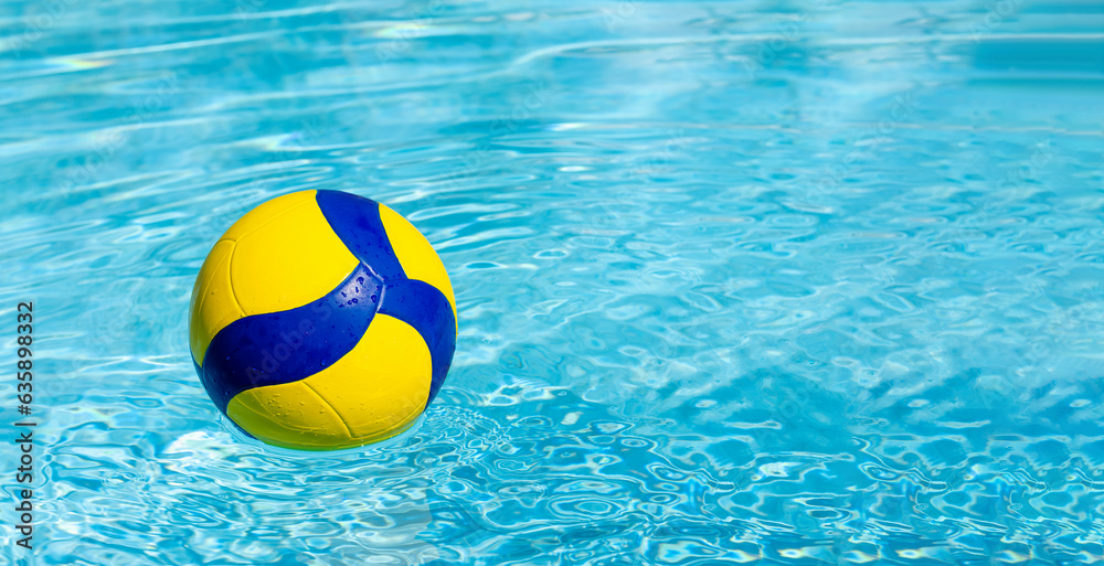 Summer active lifestyle, ball for water volleyball on surface of water of swimming pool in resort.