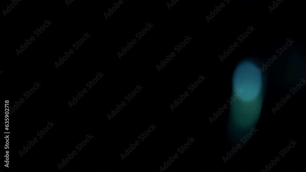 Real anamorphic lens flare from bright flash of light with blue leaks and bokeh, on right side of frame, video for effect of overlay and transitions. Real anamorphic lens flare from bright flash of light with blue leaks and bokeh, on right side of frame, video for effect of overlay and transitions.