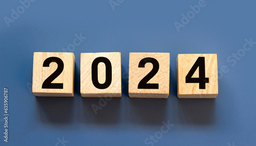 2024 displayed on wooden letter blocks on lite Indigo background.