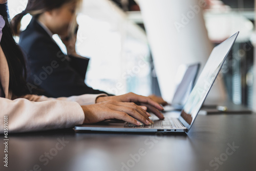Businesswoman typing on laptop keyboard.