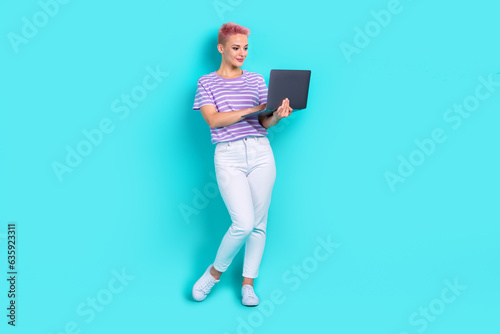 Full length photo of young employee lady remote job hold netbook no need office for hiring people isolated on aquamarine color background
