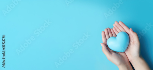 Foto Hand holding blue heart, World health day, Health care and mental health concept