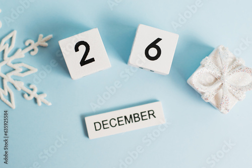 Boxing Day  wooden calendar with the date December 26 on a blue background with decor  flatlay. The concept of preparing for the celebration of Christmas and New Year and plans for the future.