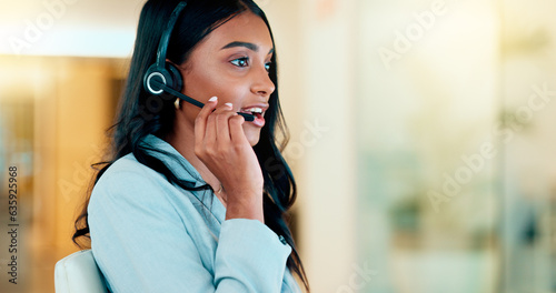 Professional and helpful call centre woman using a headset, assists business consult. Helpful support service agent talks with client on call. Remote worker gives client advice telephonically photo