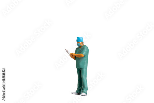 Miniature people young doctor in scrubs Isolated on white background with clipping path © Sirichai Puangsuwan