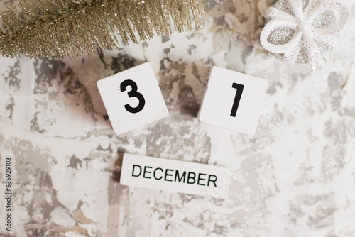 Flatlay, Christmas decoration and wooden calendar with date December 31 on light background, New Year. The concept of preparing for the celebration of Christmas and New Year and plans for the future.
