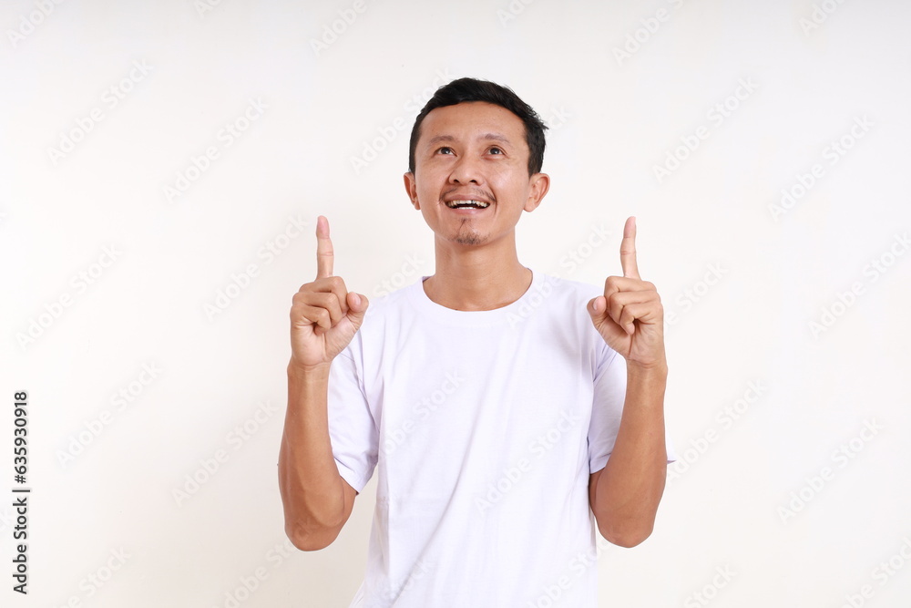 Happy asian funny man pointing something above him. Isolated on white background Happy asian funny man pointing something above him. Isolated on white background