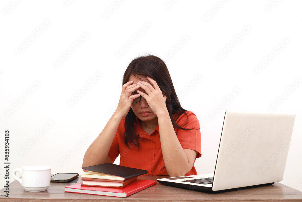 Stressed young asian entrepreneur woman sitting while holding her head. Isolated on white