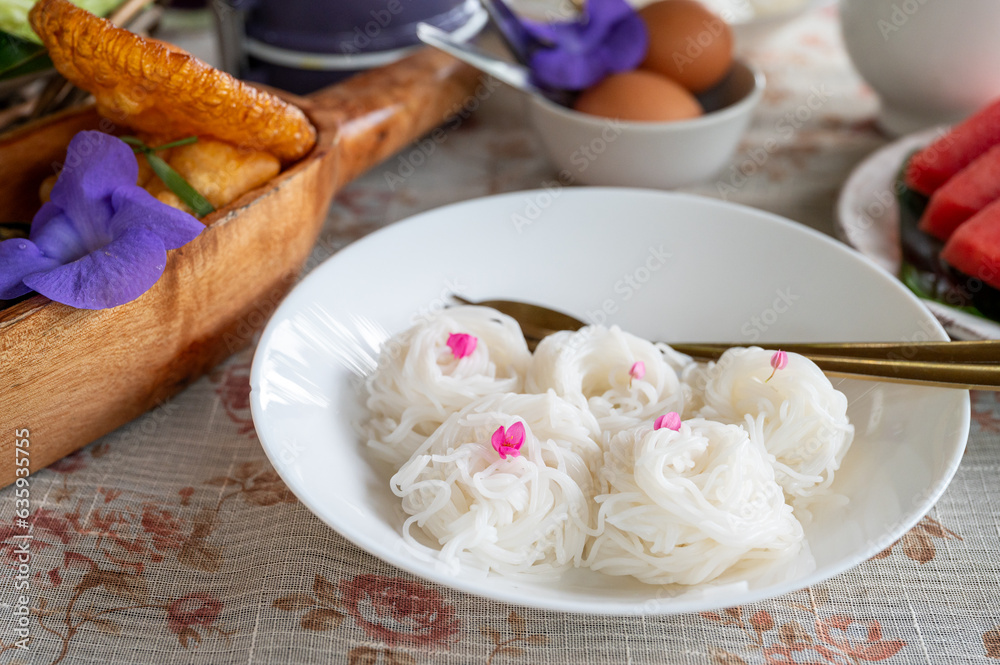 Thai rice noodles or Kanom Jeen in dish on table Thai rice noodles or Kanom Jeen in dish on table