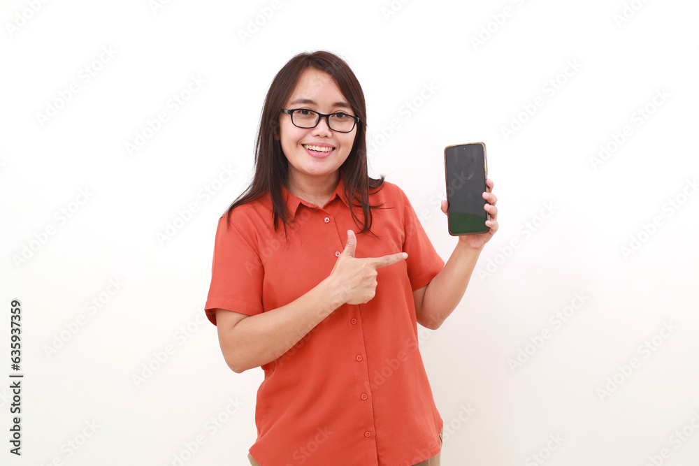 Happy asian woman showing a blank cell phone screen while pointing on it. Isolated on white Happy asian woman showing a blank cell phone screen while pointing on it. Isolated on white