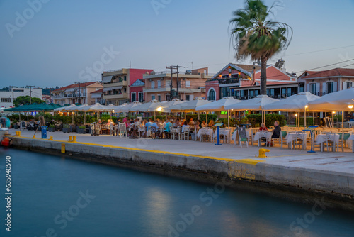 View of cafe and restaurant at the harbour at dusk, Lixouri, Kefalonia, Ionian Islands, Greek Islands, Greece photo