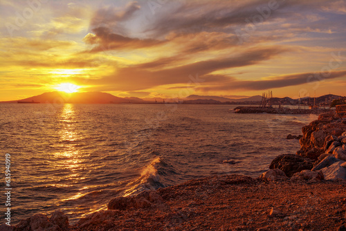 Beautiful sunset on the sea. Golden hour in the city of Malaga  Spain. Mountains  sun  sea  ship. Spanish resort