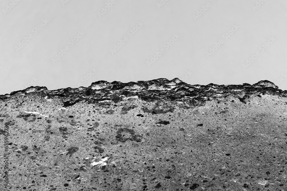 A broken concrete ledge in black and white. A broken concrete ledge in black and white.