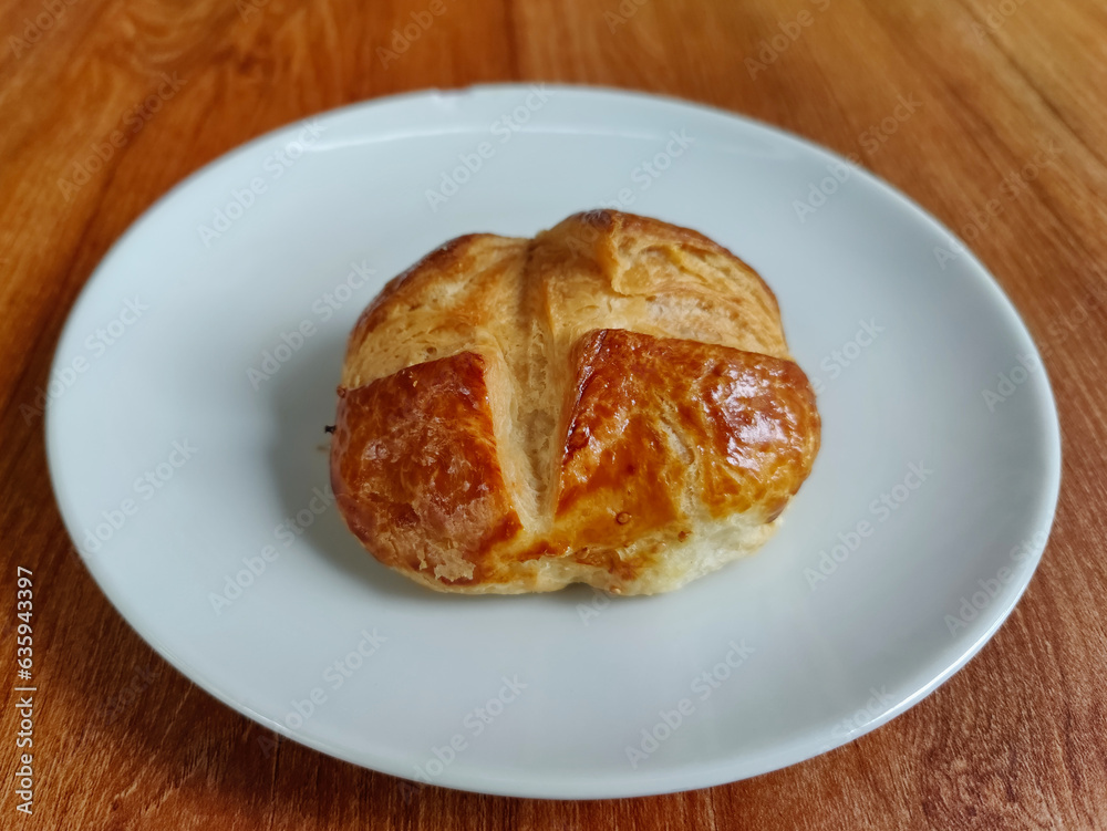 plain patisserie pogaca on a white plate, traditional Turkish pastry plain patisserie pogaca on a white plate, traditional Turkish pastry