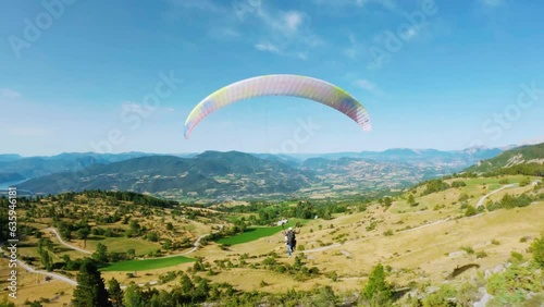Explore paragliding in the French Hautes-Alpes, near Lake Serre-Ponçon, during summer. Captivating aerial view captured by drone