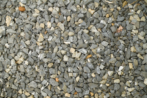 Various crushed rocks cover an entire frame of a photo. Nature, construction, background themes, and concepts.