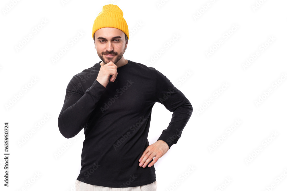 portrait of a smart young 30s authentic brunette male adult with a beard in a black sweater on a white background with copy space portrait of a smart young 30s authentic brunette male adult with a beard in a black sweater on a white background with copy space