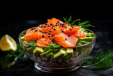 Salmon salad with avocado in glass bowl on black stone background