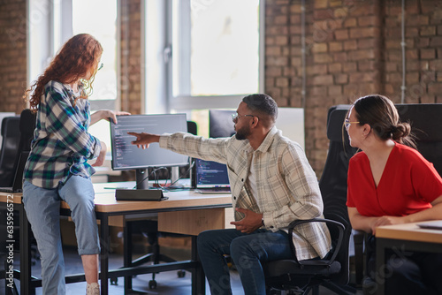 A diverse group of young business individuals congregates in a modern startup coworking center, embodying collaborative innovation and a dynamic atmosphere.