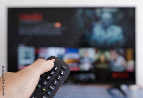 Photo of a hand holding a remote control