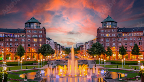 Mannheim, Germany. View on Friedrichsplatz at sunset with fountain creating splendid water and color effects. 2013-06-16.