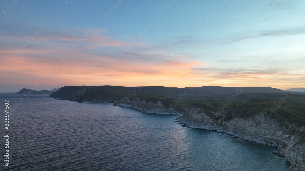 Stunning aerial view of cliffs overlooking the ocean at sunset
