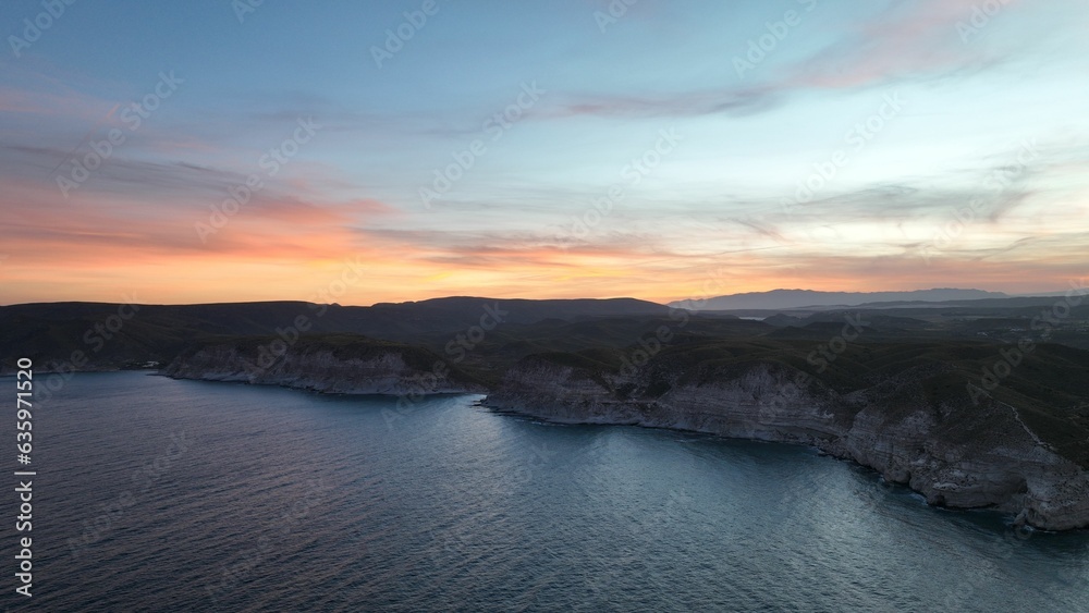 Beautiful aerial view of cliffs overlooking the ocean at sunset