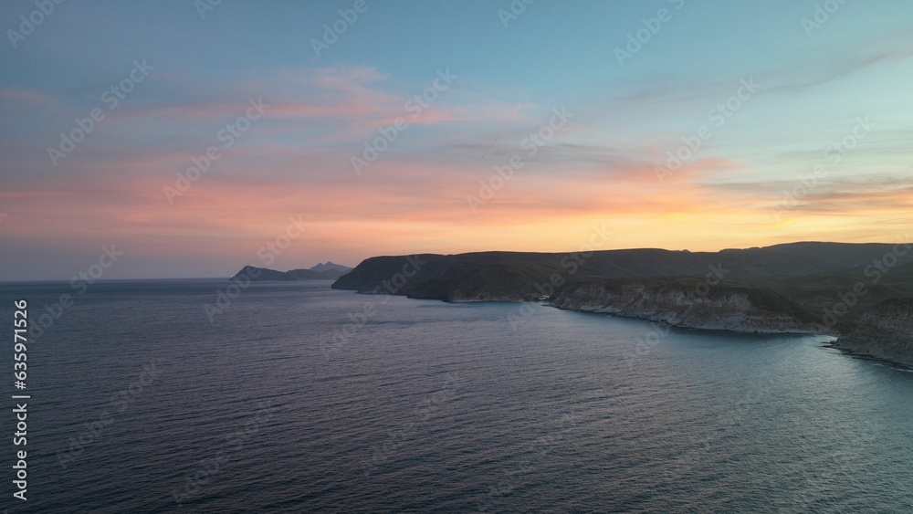 Aerial view of cliffs overlooking the ocean at sunset Aerial view of cliffs overlooking the ocean at sunset