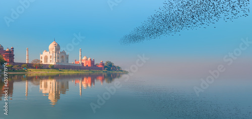 Taj Mahal monument reflecting in water of the river, Agra, India photo