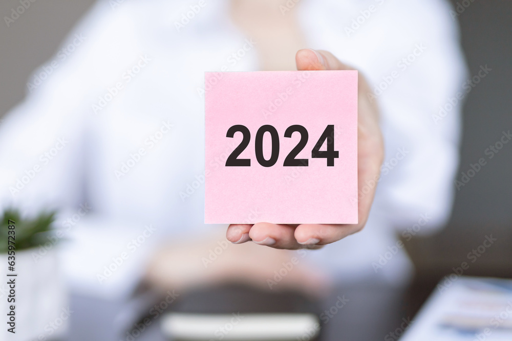 New year 2024 hand write on note sticker. New Goals, Plans, and Numbers for Next Year. Business strategy. New year 2024 hand write on note sticker. New Goals, Plans, and Numbers for Next Year. Business strategy.