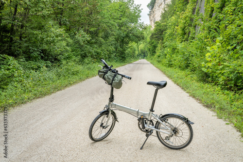 lightweight folding bike on Katy Trail near Rocheport, Missouri, summer scenery. The Katy Trail is 237 mile bike trail converted from an old railroad.