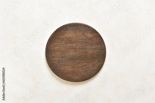 Wooden dark cutting board over light background