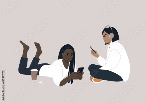 Two adolescents engrossed in their electronic devices, their interaction transitioning from the physical world to the virtual realm of online social media
