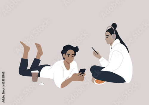 Two adolescents engrossed in their electronic devices, their interaction transitioning from the physical world to the virtual realm of online social media