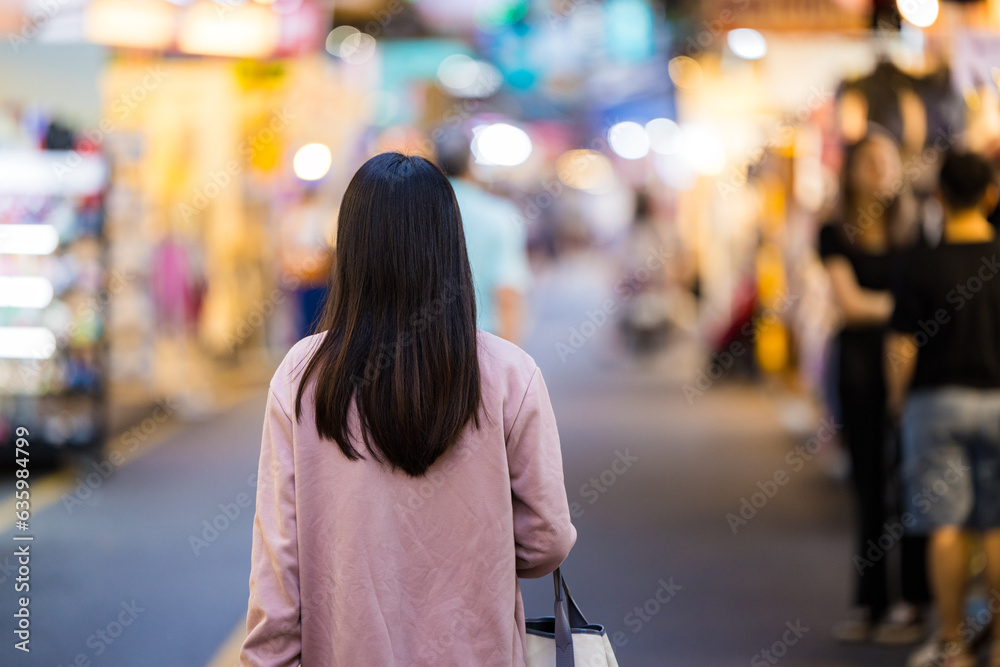 Tourist woman go street market at night in Taiwan Tourist woman go street market at night in Taiwan