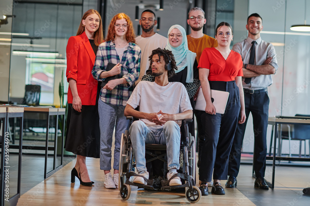 Fototapeta premium A diverse group of young business people congregates within a modern startup's glass-enclosed office, featuring inclusivity with a person in a wheelchair, an African American young man , and a hijab