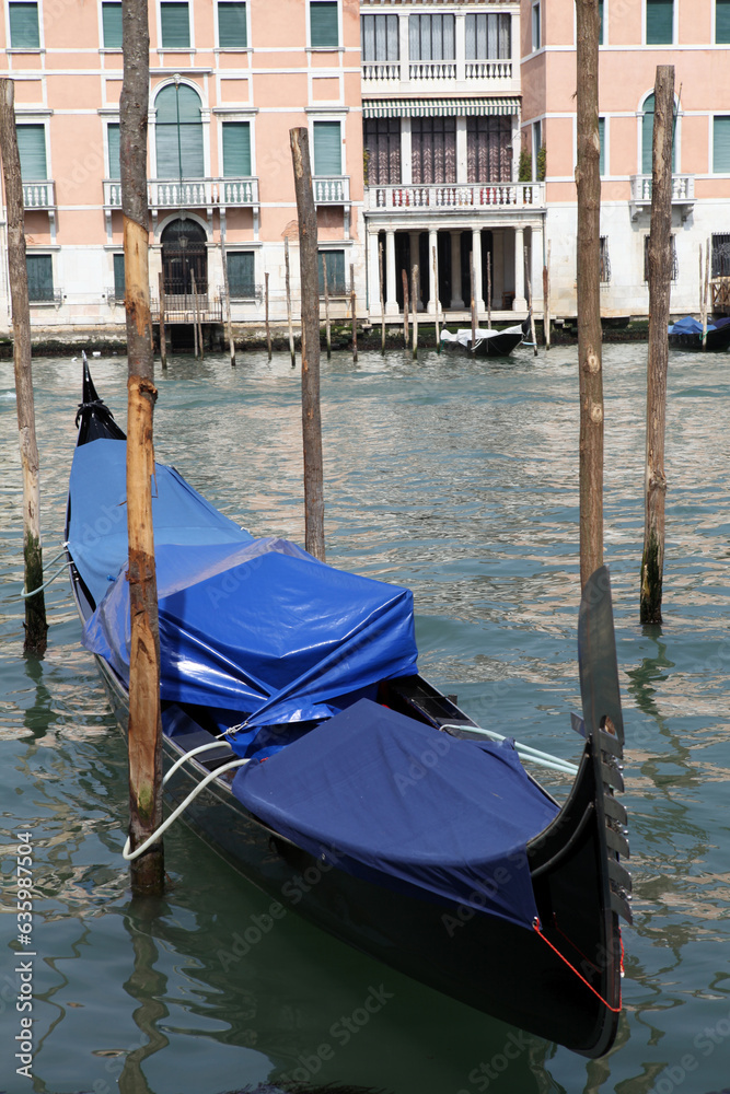 View of gondolas and poles in the canal grande from Campo di Salute - Venice - Italy
