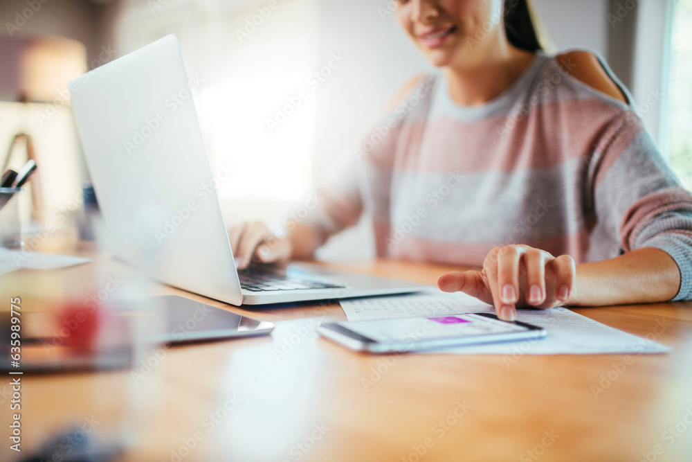 Naklejka premium Young caucasian woman using laptop while working and studying at home