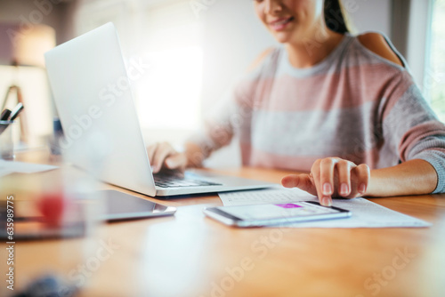 Young caucasian woman using laptop while working and studying at home