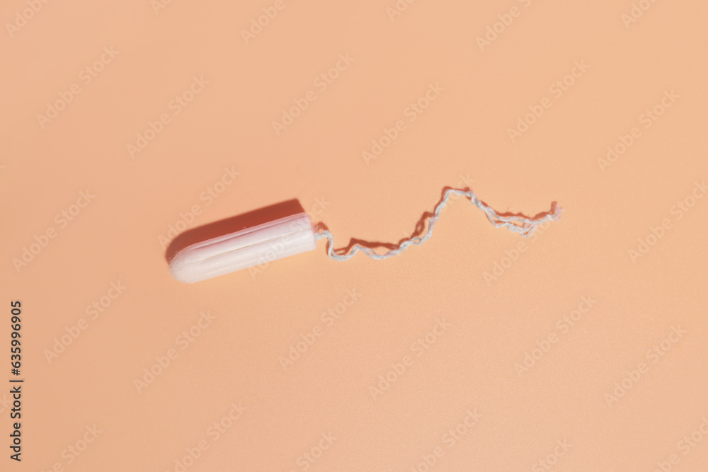 hygienic tampon on a light background, the concept of hygiene of critical days
