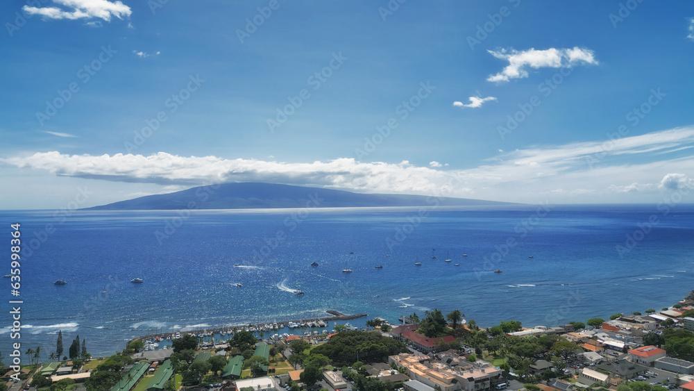 Lahaina from above, in west Maui, Hawaii. With the island of Lanai in the background. Aerial drone image shot April 11, 2023.  The village of Lahaina burned down four months later, on August 8, 2023.