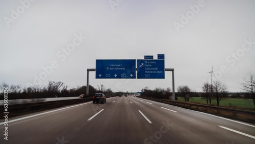 Stretch of an empty interstate highway with signs on either side of the road