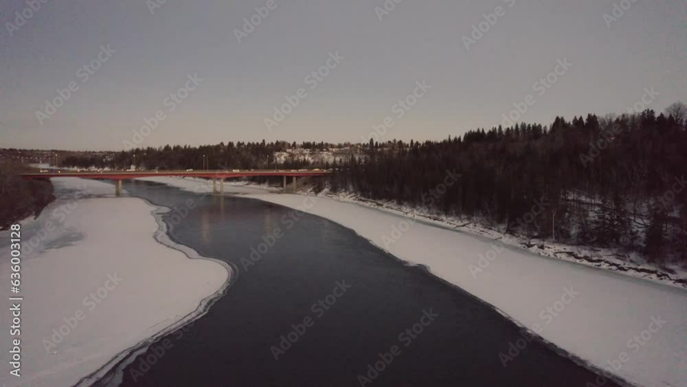 Aerial of the traffic on the bridge over the frozen lake during a cold winter day Aerial of the traffic on the bridge over the frozen lake during a cold winter day