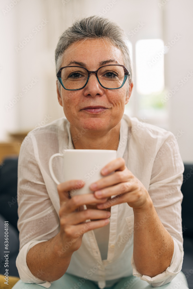 Front view of a senior woman holding a cup. Front view of a senior woman holding a cup.