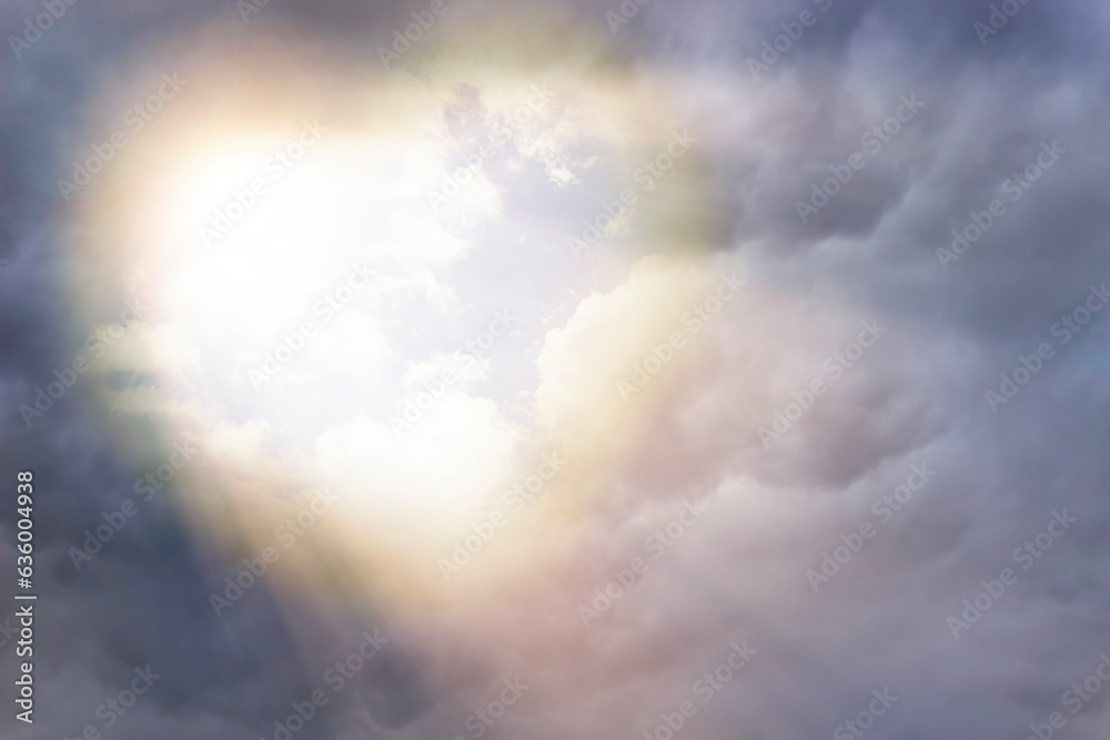 heart in the sky among the clouds. Sunlight in a cloudy sky in the shape of a heart. Beautiful love background with copy space